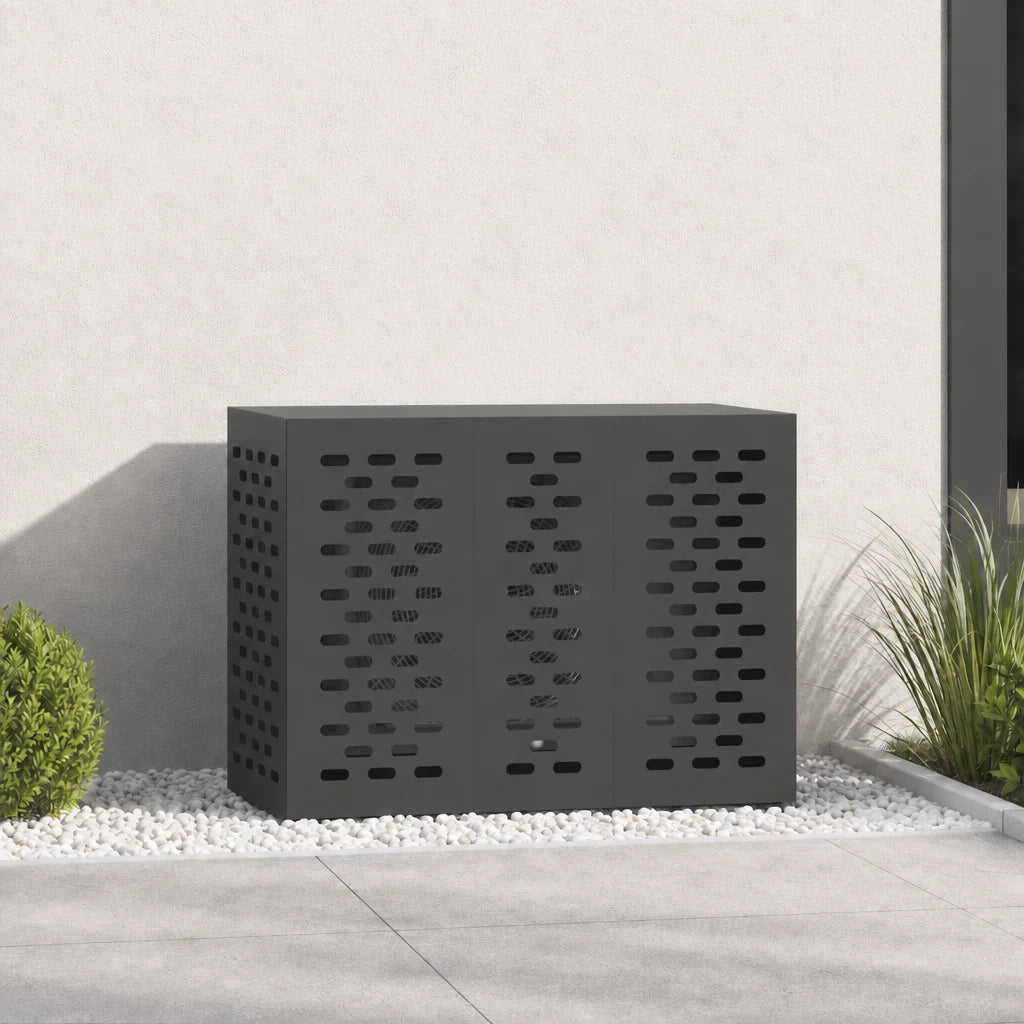 Cache clim extérieur noir contre un mur, vue rapprochée sur galets
