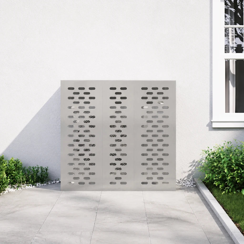Cache climatiseur inox installé contre une façade, à proximité d'un arbuste